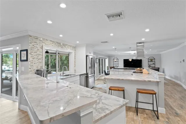 a bathroom with a granite countertop double vanity sink and a mirror