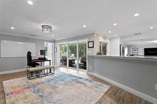 a view of a swimming pool with a patio and a garden