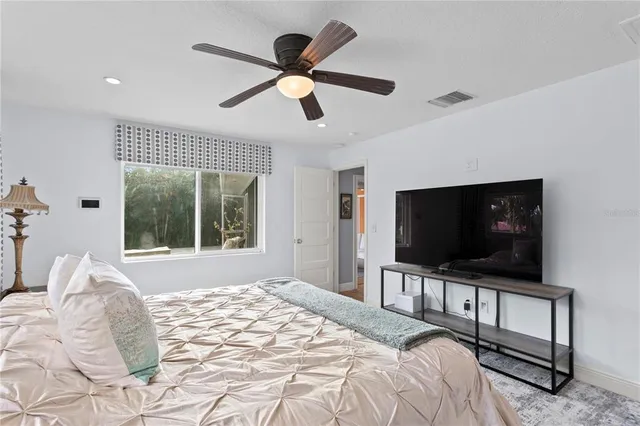 an aerial view of a house swimming pool a patio and lake view