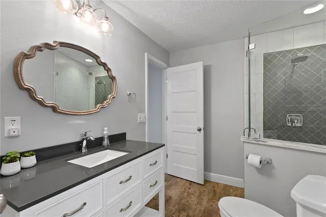 an aerial view of residential houses with outdoor space and parking