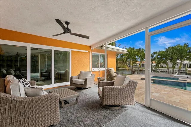 a view of a house with swimming pool and sitting area