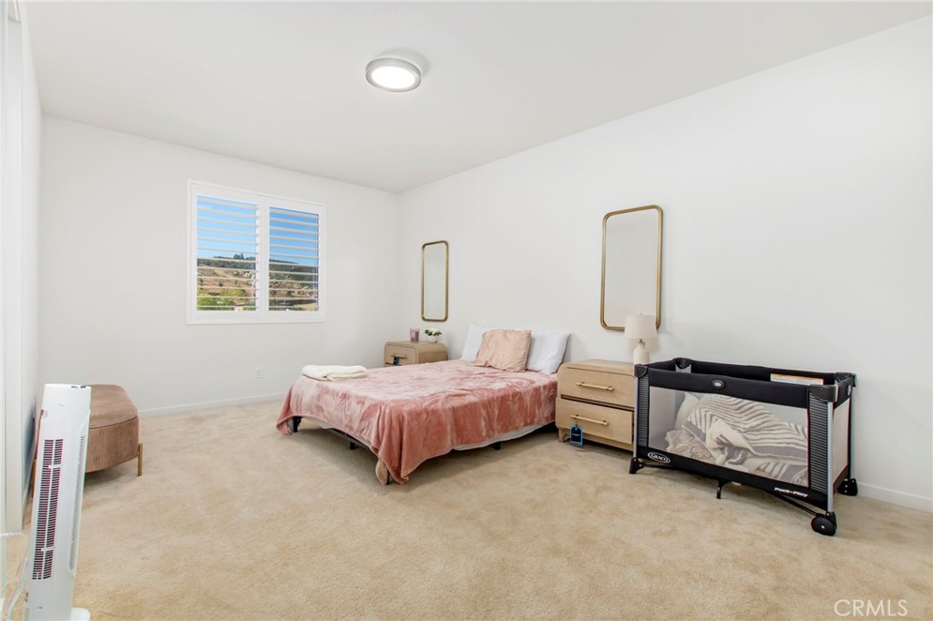 32797 Hayden Road Menifee, CA 92584 - Photo 27 of 51 a spacious bedroom with a bed and a window