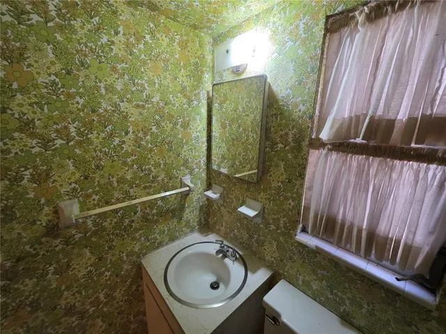a bathroom with a sink a mirror and shower