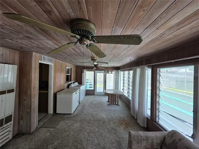 a view of a livingroom with furniture and a ceiling fan