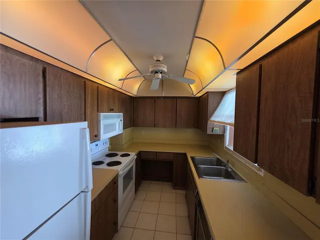 a kitchen with a sink and a refrigerator