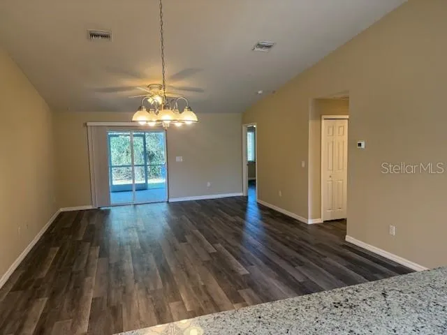 a view of a livingroom with wooden floor and a ceiling fan