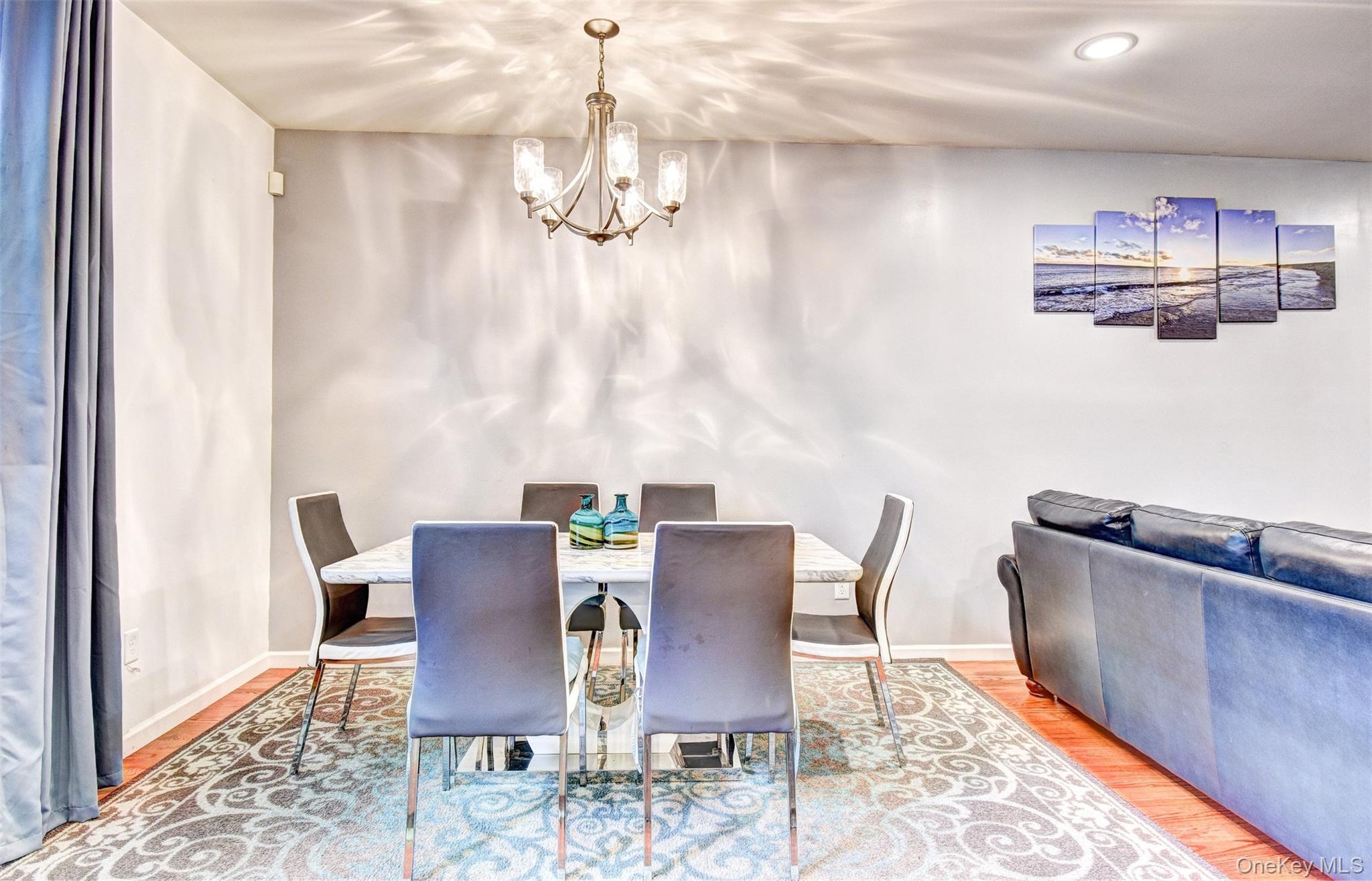 17 Magnolia Park Road Middletown, NY 10940 - Photo 10 of 35 a view of a dining room with furniture a chandelier and wooden floor
