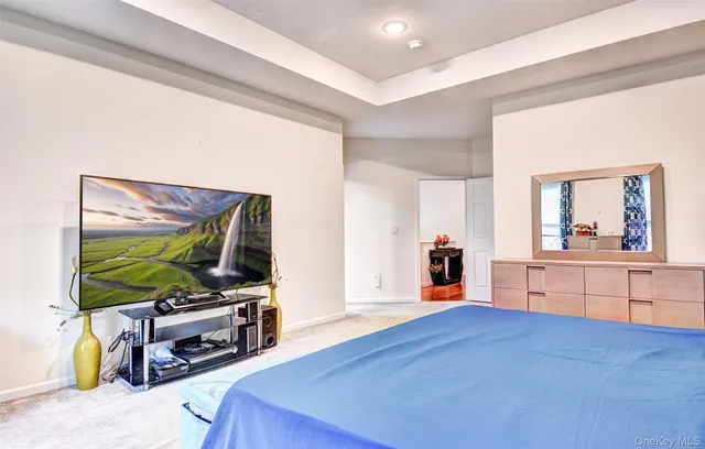 a bedroom with a bed and large windows