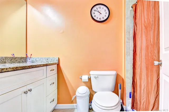 a bedroom with a bed and a table in it with window