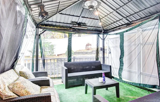 a living room with furniture and flat screen tv