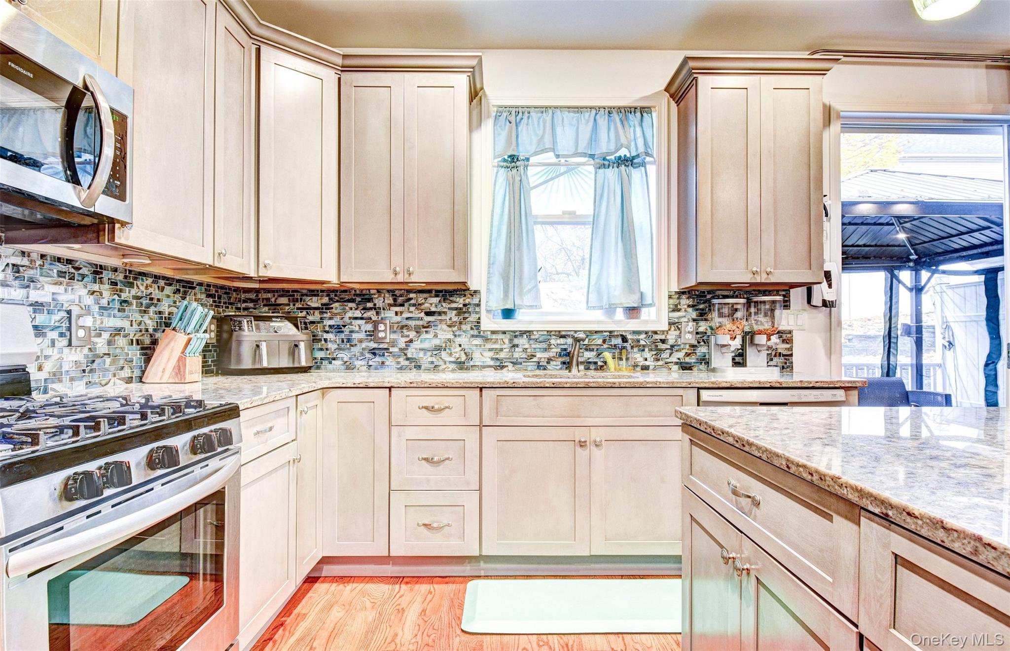 17 Magnolia Park Road Middletown, NY 10940 - Photo 4 of 35 a kitchen with granite countertop a sink a stove and cabinets
