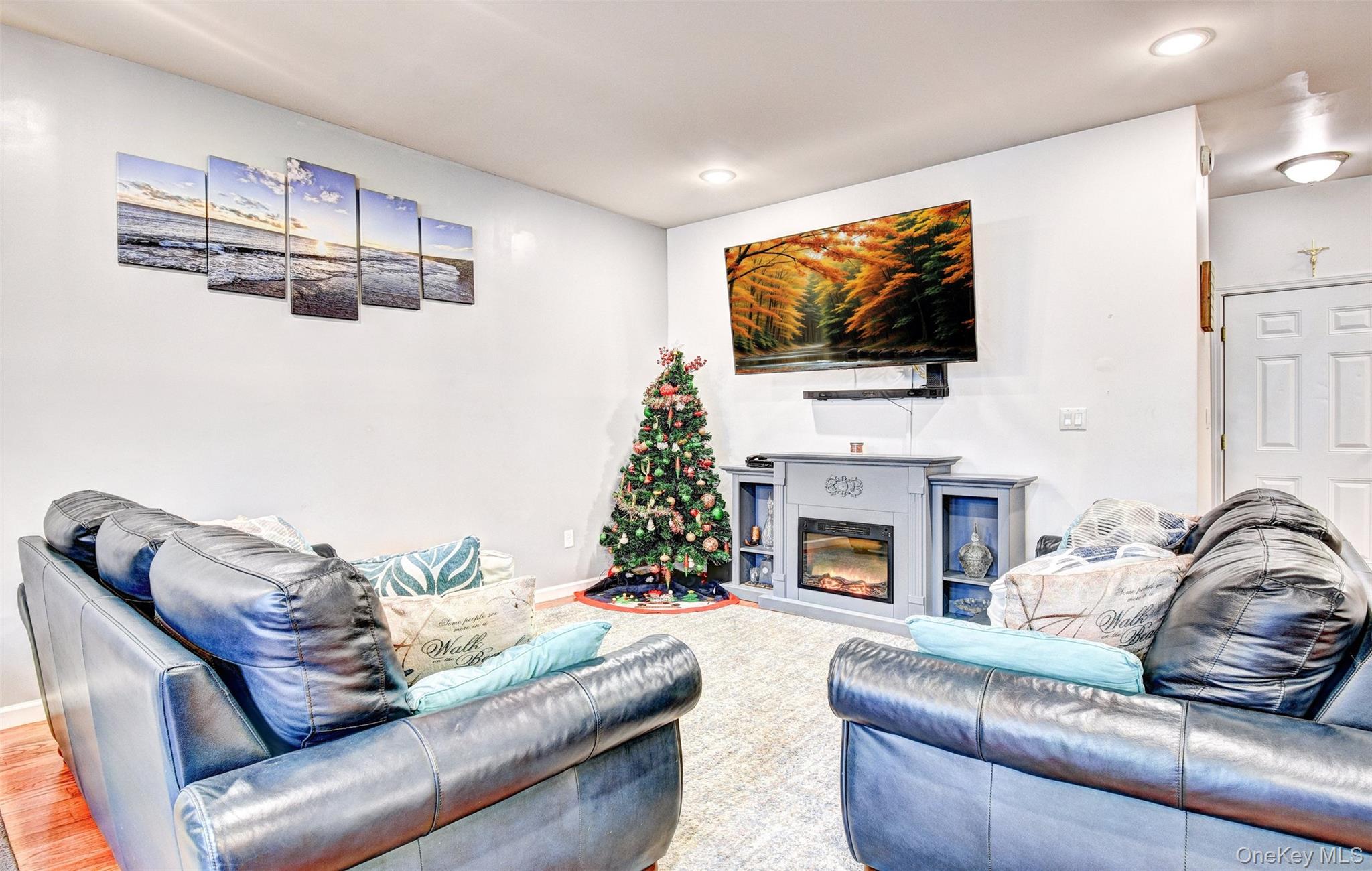 17 Magnolia Park Road Middletown, NY 10940 - Photo 6 of 35 a living room with furniture a flat screen tv and a fireplace