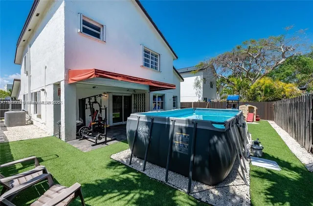 a view of a chairs and table in backyard of the house