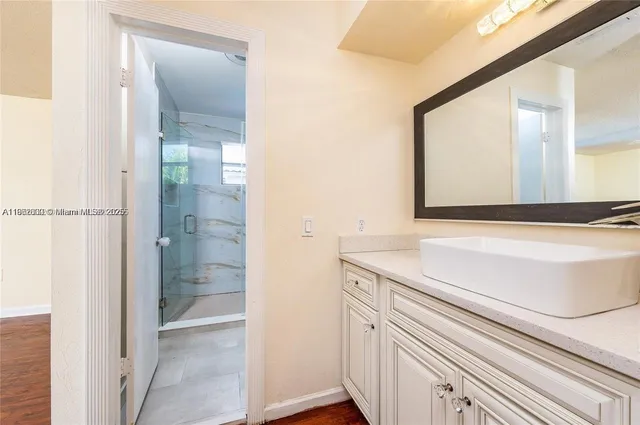 a bathroom with a sink and a mirror
