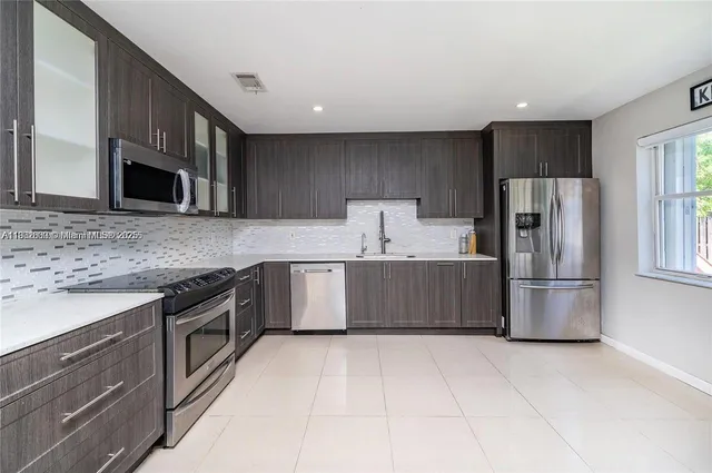 a kitchen with a refrigerator sink and microwave