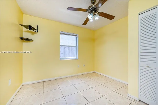 a view of a room with a ceiling fan and shower