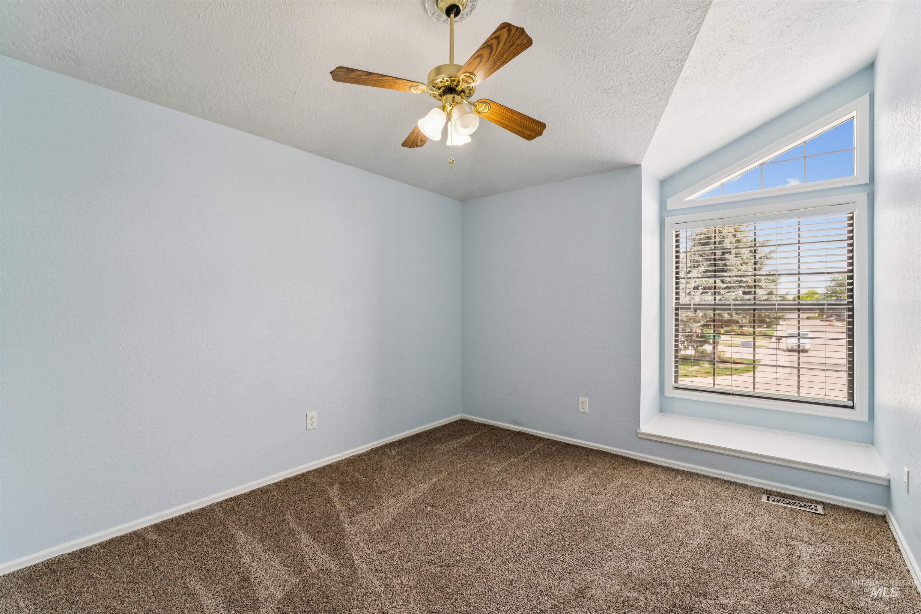 9831 West Ripley Street Boise, ID 83704 - Photo 32 of 47 Room featuring light gray walls, white baseboards, and wood-finish ceiling fan with brass accents