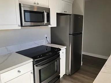 1091 Reed Avenue, Unit D Sunnyvale, CA 94086 - Photo 3 of 11 a kitchen with granite countertop white cabinets and stainless steel appliances