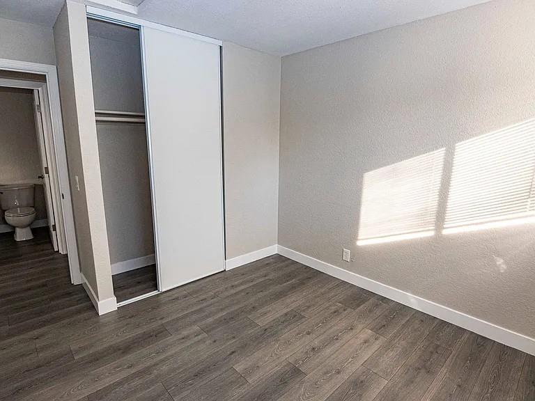 1091 Reed Avenue, Unit D Sunnyvale, CA 94086 - Photo 8 of 11 an empty room with wooden floor and a window