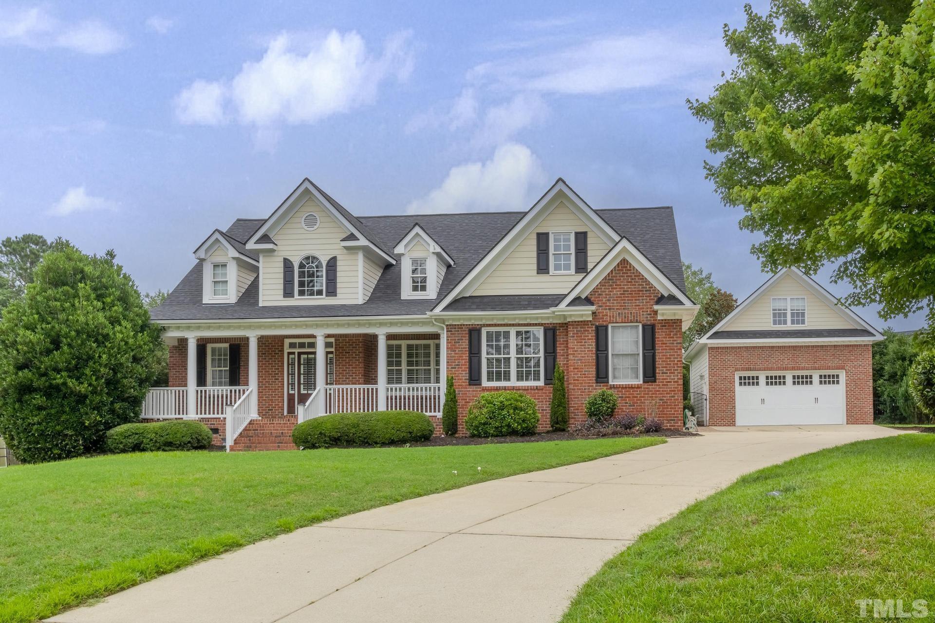 5701 Turner Store Lane Raleigh, NC 27603 - Photo 54 of 60 a front view of a house with a yard and garage
