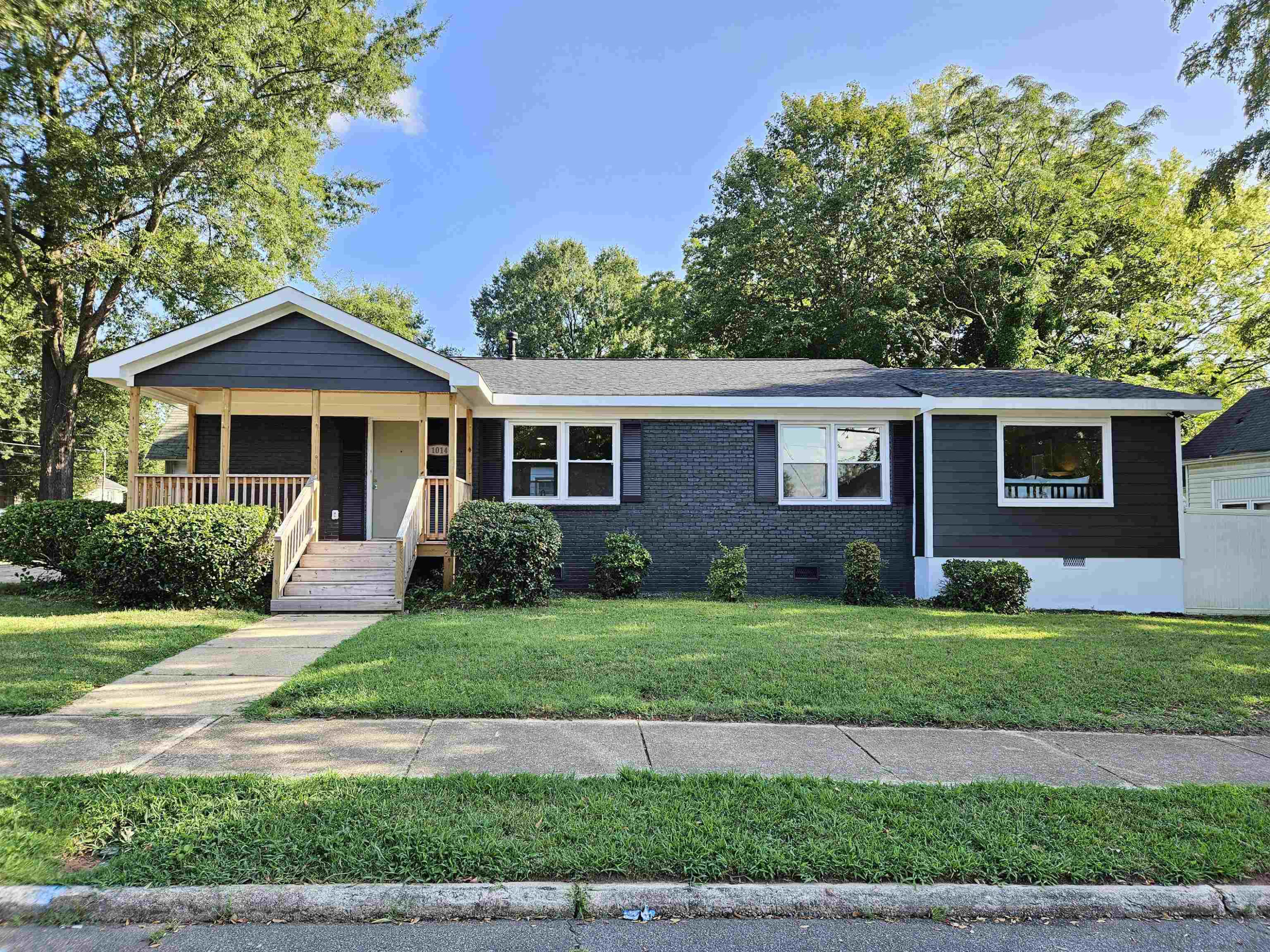 1014 East Jones Street Raleigh, NC 27601 - Photo 1 of 14 a front view of a house with a yard