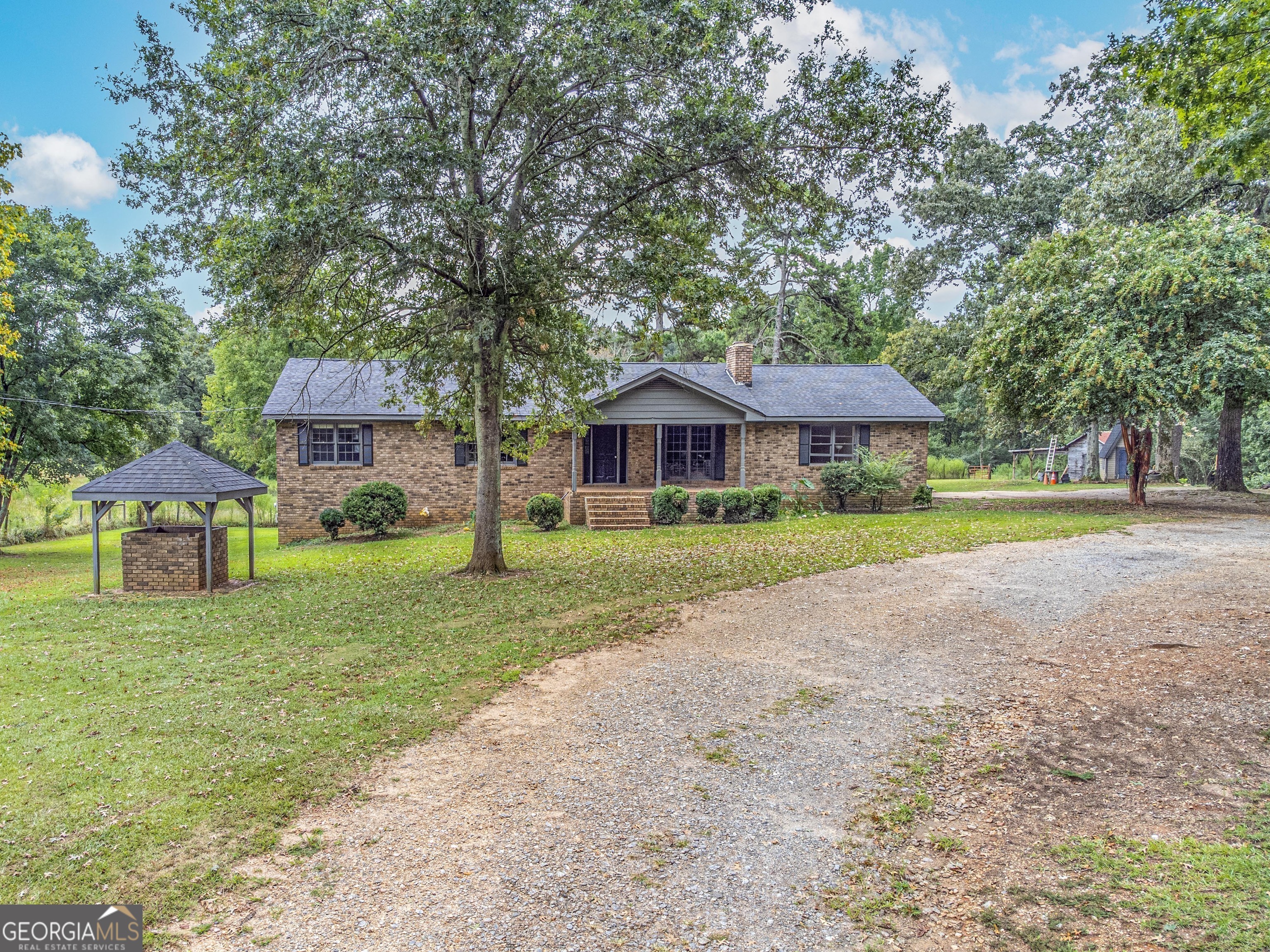 462 Wall Road Statham, GA 30666 - Photo 1 of 1 a front view of a house with a yard and trees