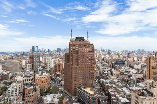 a living room with furniture and floor to ceiling window