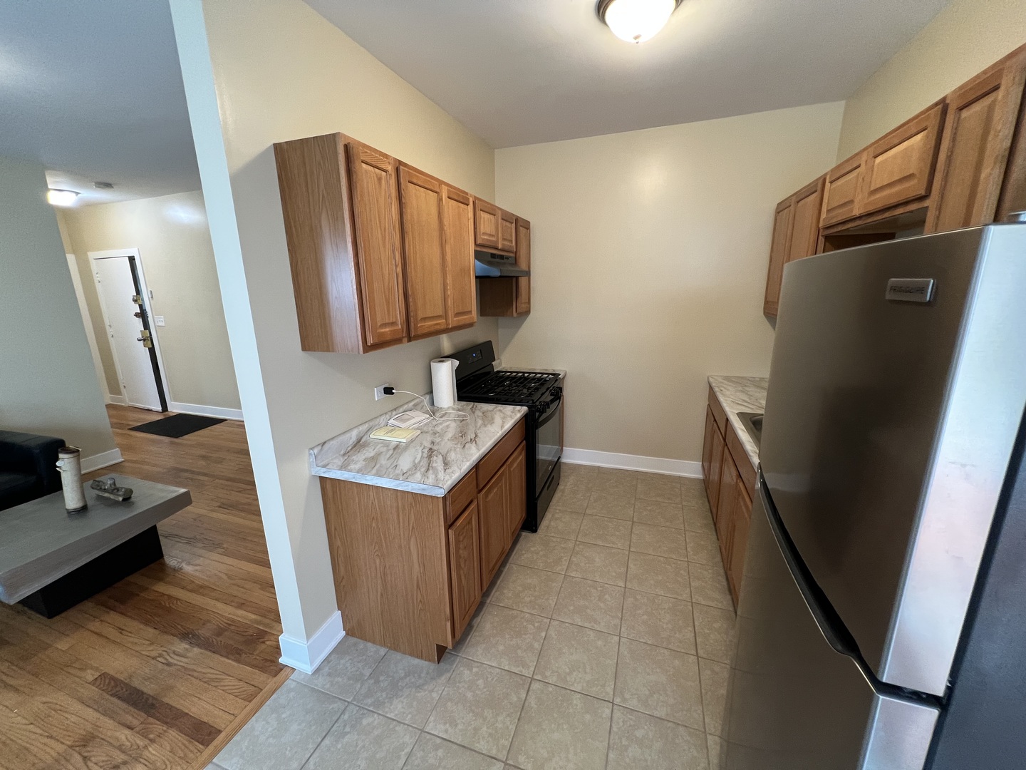 7506 South Vernon Avenue, Unit 3C Chicago, IL 60619 - Photo 4 of 10 a bathroom with a sink a mirror and a refrigerator