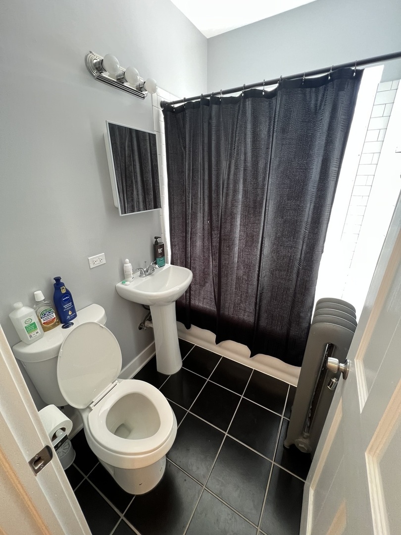 7506 South Vernon Avenue, Unit 3C Chicago, IL 60619 - Photo 7 of 10 a bathroom with a sink toilet a mirror and tub