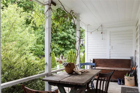 a view of a balcony with table and chairs
