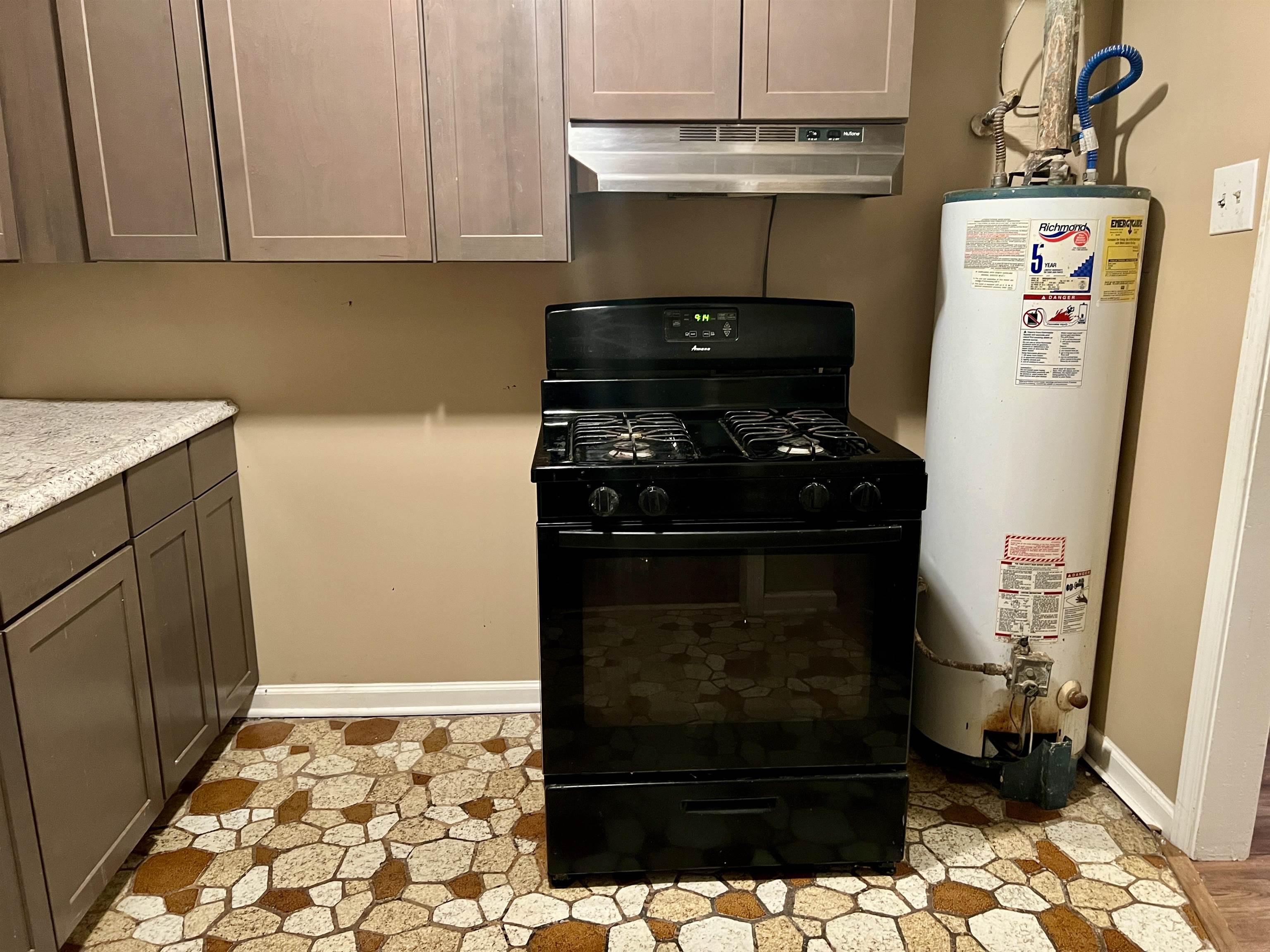 289 West Brooks Road Memphis, TN 38109 - Photo 11 of 31 Kitchen featuring black range with gas stovetop and water heater