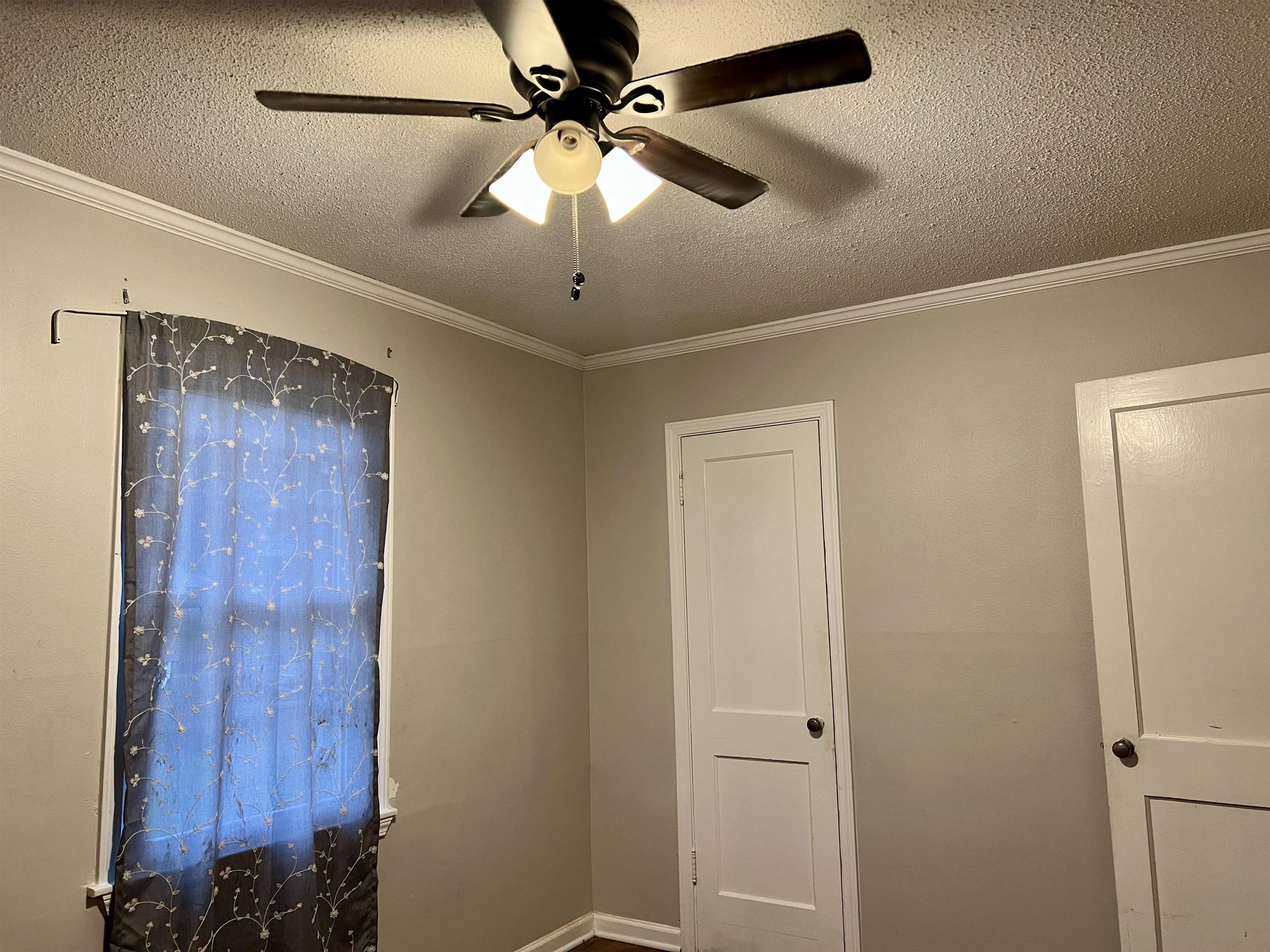 289 West Brooks Road Memphis, TN 38109 - Photo 17 of 31 Interior space with a textured ceiling, ceiling fan, and ornamental molding