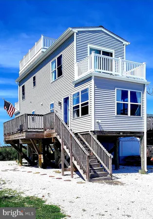 a view of a house with wooden fence