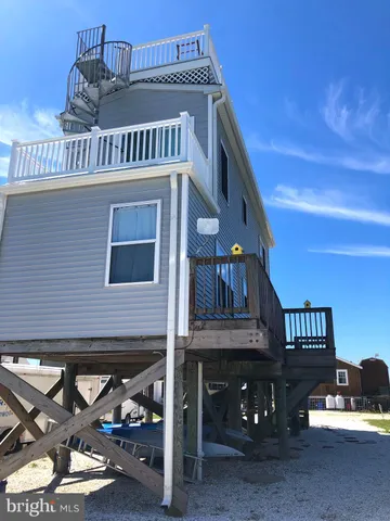 a view of a house with wooden deck