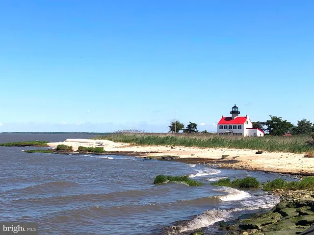a kitchen with stainless steel appliances white cabinets and wooden floors