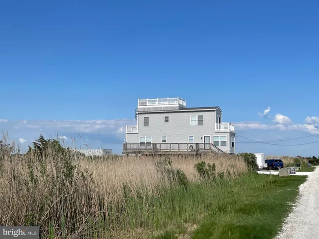 a view of a house with wooden floor and a yard