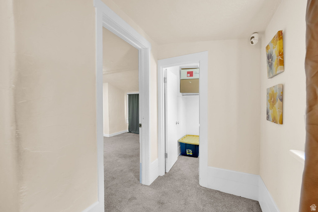 501 Canyon Road Ogden, UT 84404 - Photo 16 of 30 Hallway with neutral wall tones, white trim, and gray carpeted flooring