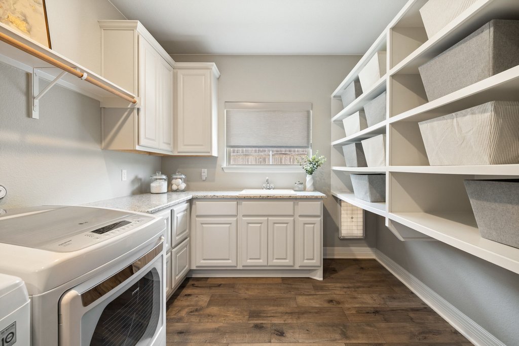 108 Berry Cove Georgetown, TX 78628 - Photo 29 of 39 a kitchen with a sink cabinets and appliances