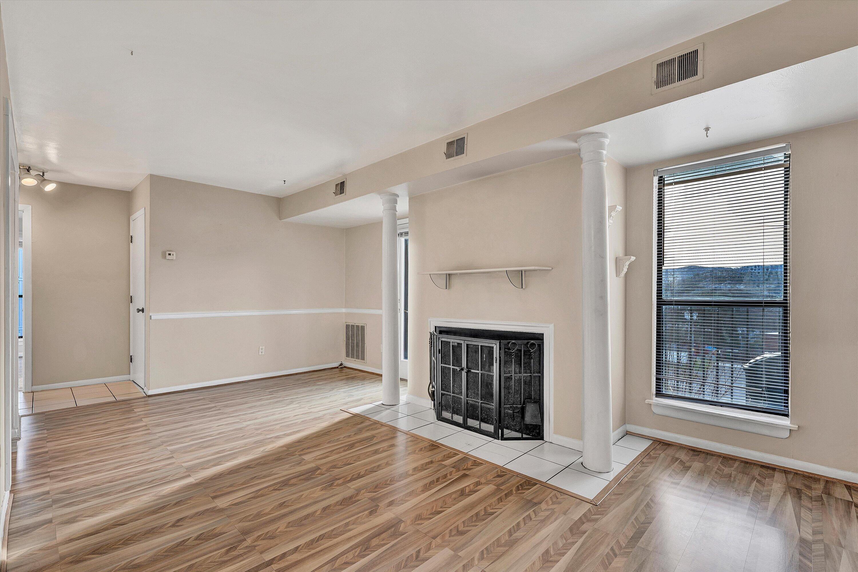3554 Timberline Trail Roanoke, VA 24018 - Photo 8 of 18 an empty room with wooden floor fireplace and windows