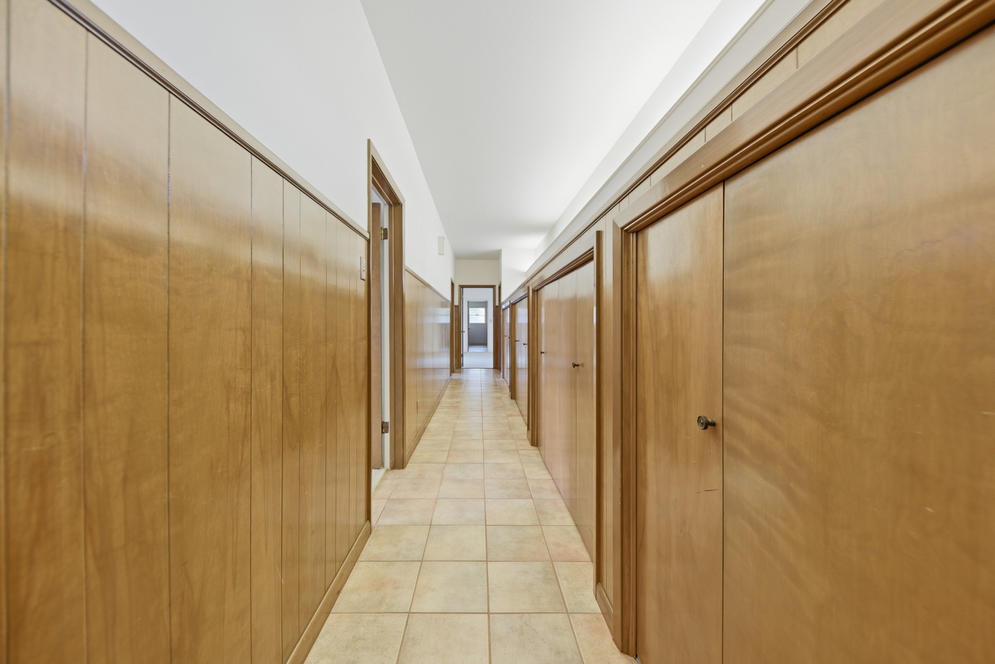 1500 Key Street Brenham, TX 77833 - Photo 23 of 41 Long hallway with plenty of storage connects three of the four bedrooms and offers patio access.