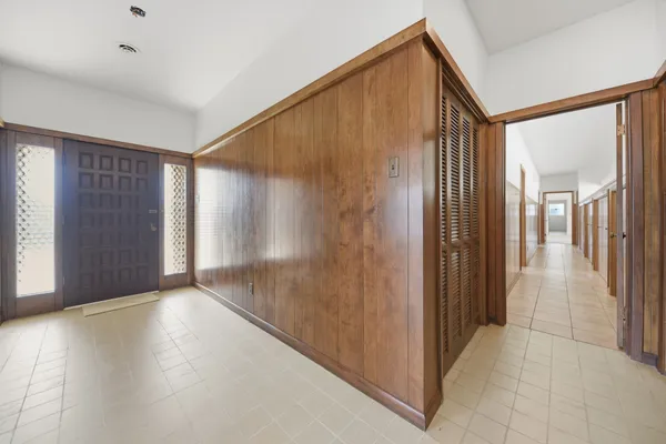 a view of a big room with closet and windows