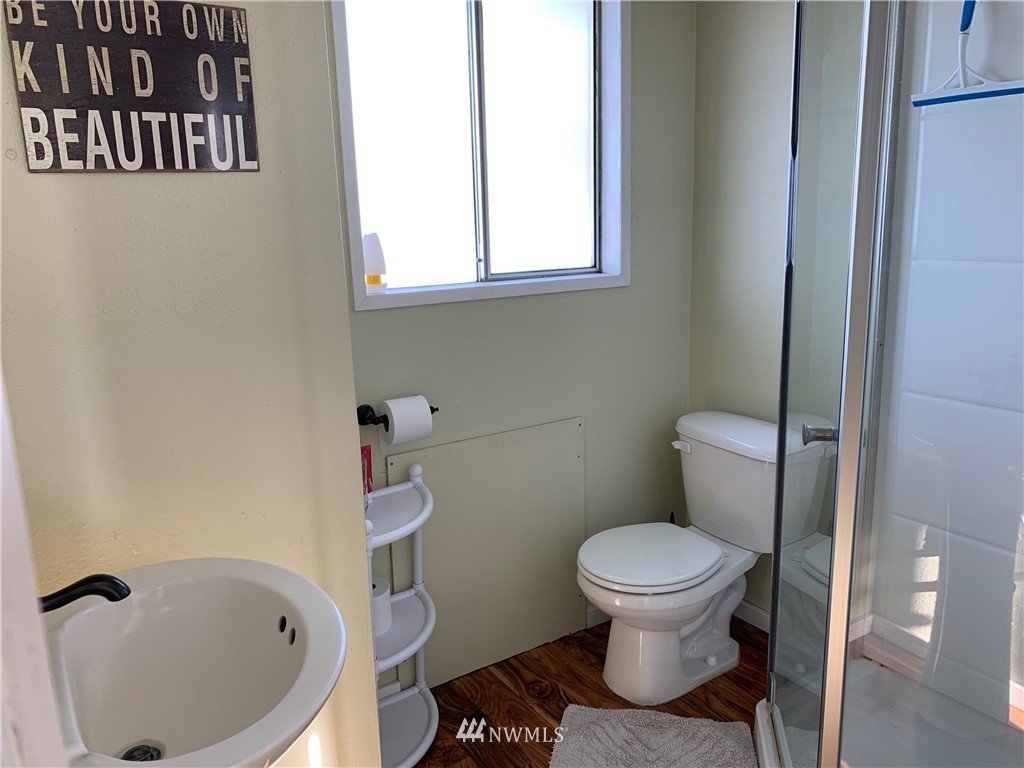 353 Maringo Road Ephrata, WA 98823 - Photo 14 of 20 a white toilet sitting next to a bathroom sink