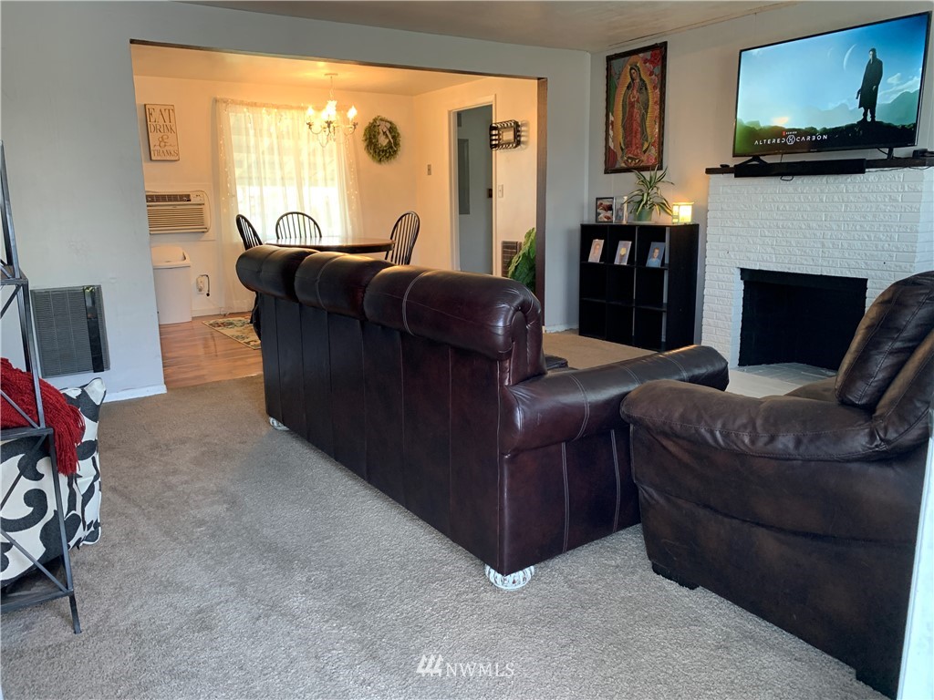 353 Maringo Road Ephrata, WA 98823 - Photo 7 of 20 a living room with furniture a fireplace and a flat screen tv