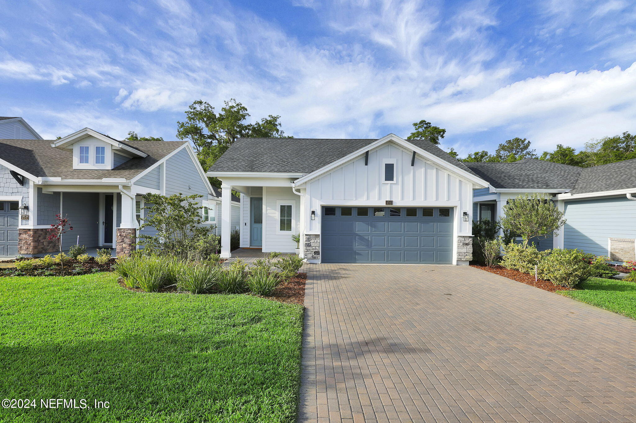 a front view of house with yard and green space