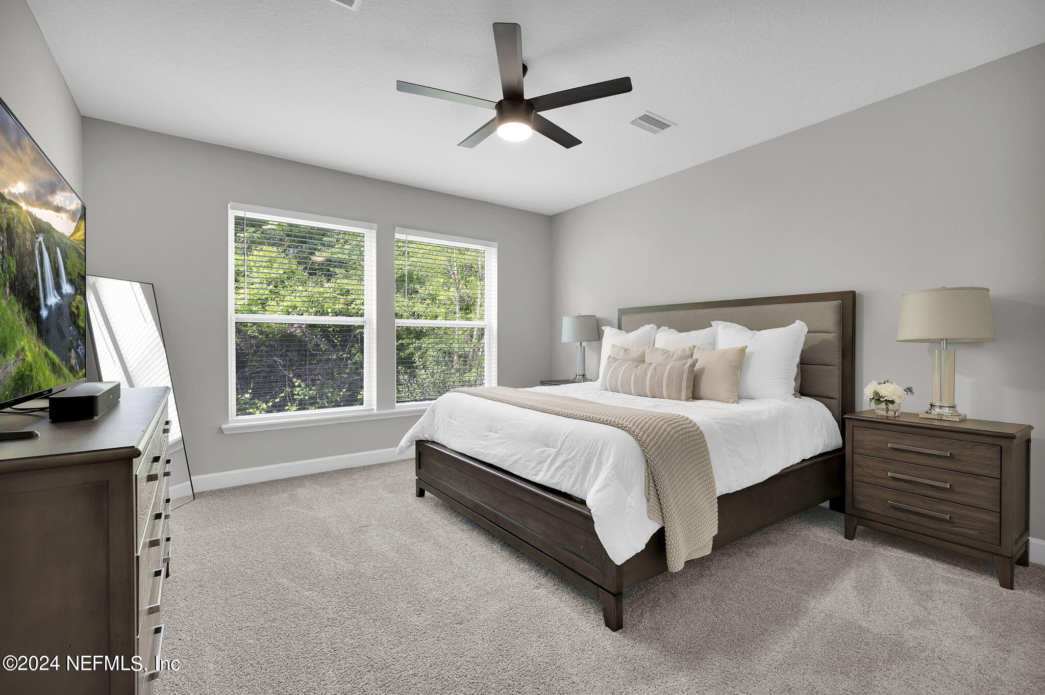175 Windswept Way Street St. Augustine, FL 32092 - Photo 17 of 80 a spacious bedroom with a bed a flat screen tv and a large window