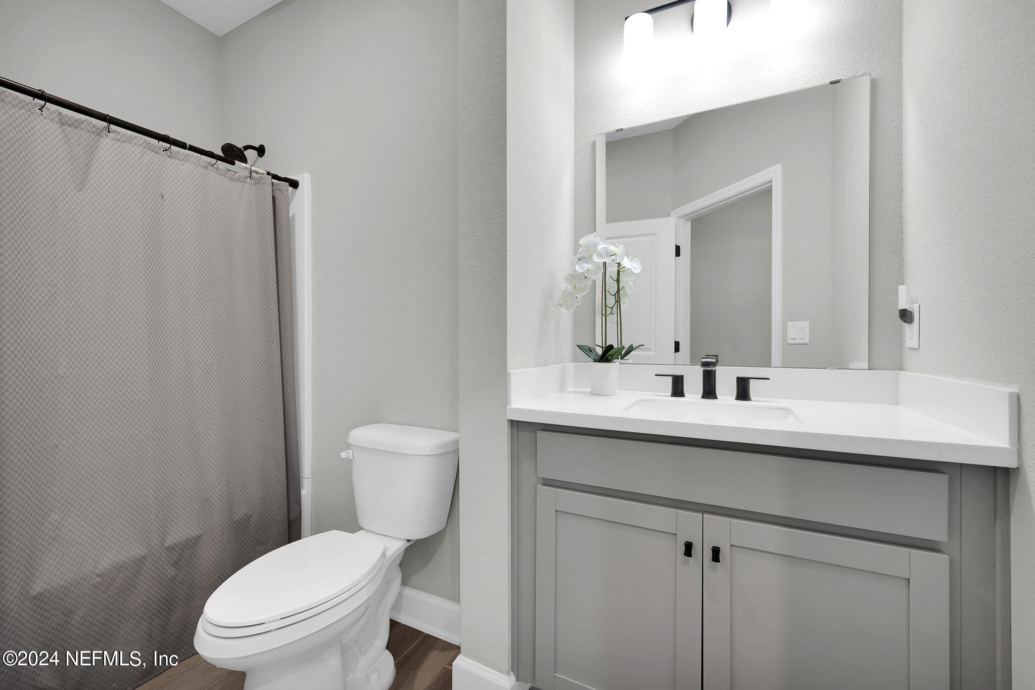 175 Windswept Way Street St. Augustine, FL 32092 - Photo 24 of 80 a bathroom with a toilet a sink a mirror and a shower