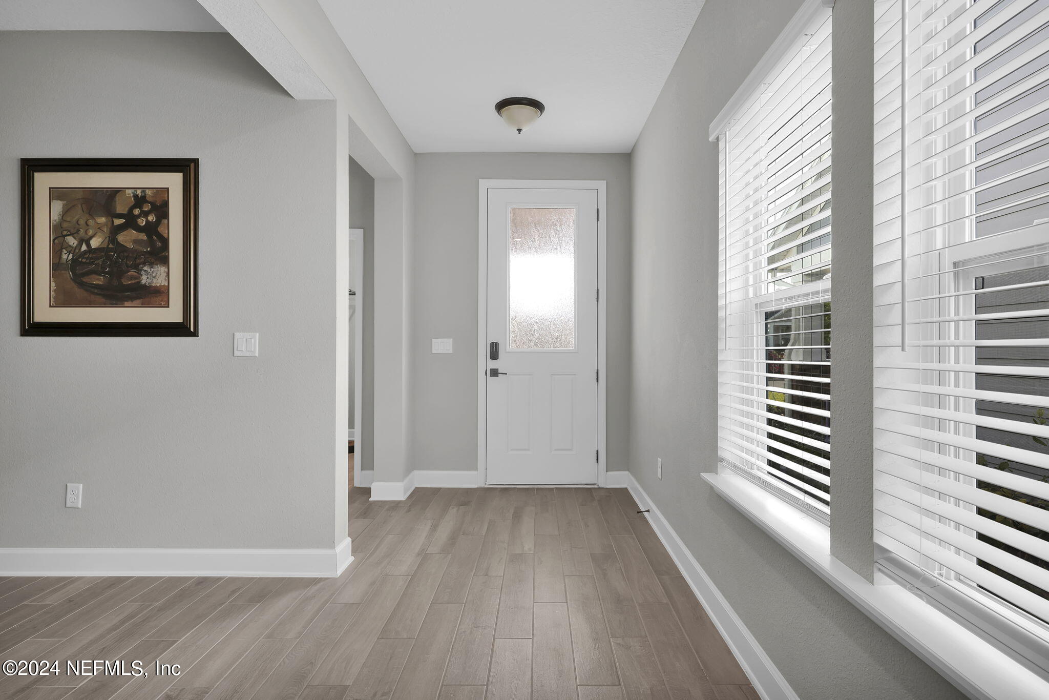 175 Windswept Way Street St. Augustine, FL 32092 - Photo 3 of 80 a view of a hallway with entryway and wooden floor