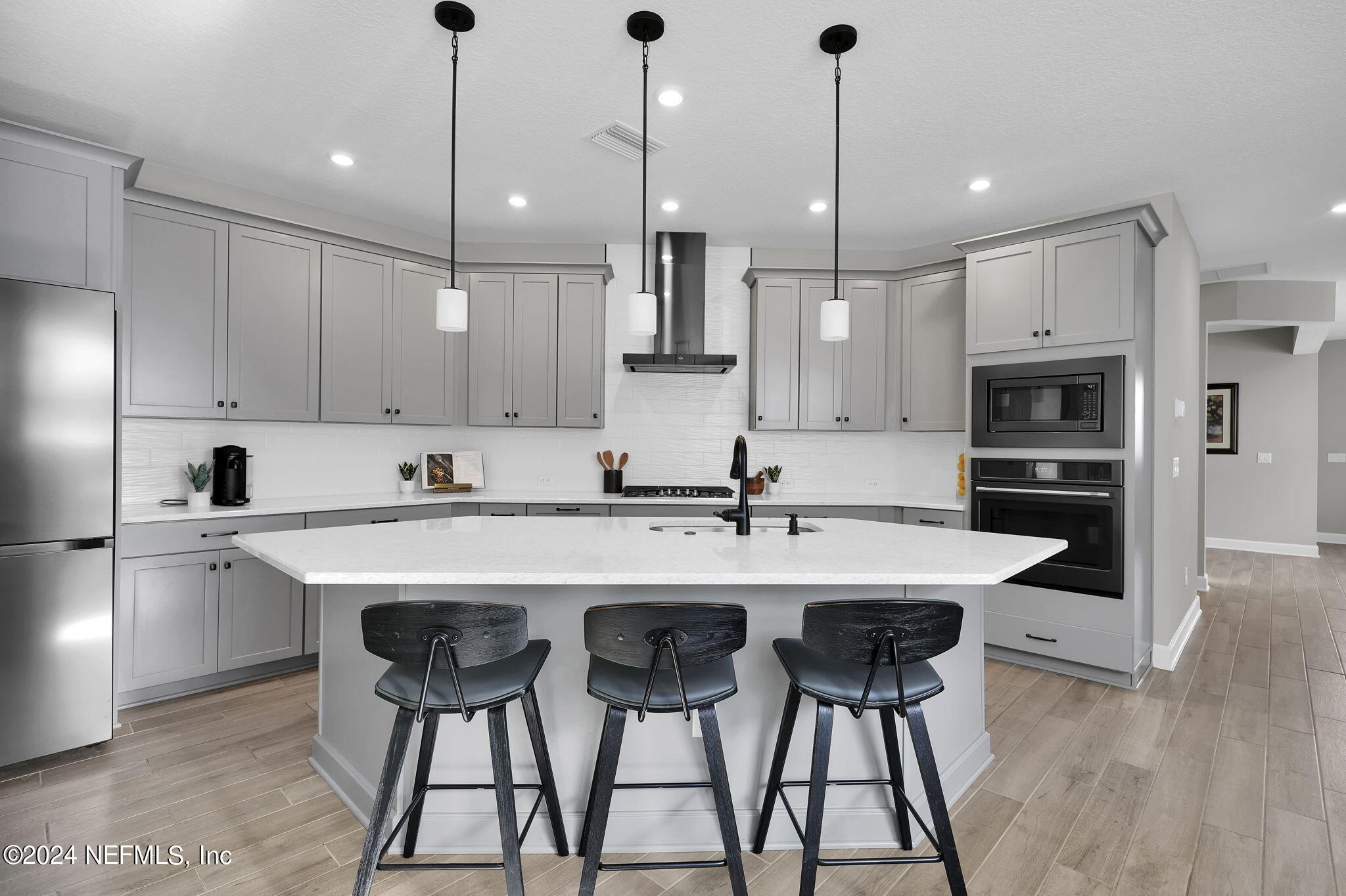 175 Windswept Way Street St. Augustine, FL 32092 - Photo 4 of 80 a kitchen with stainless steel appliances kitchen island granite countertop a dining table chairs sink and cabinets