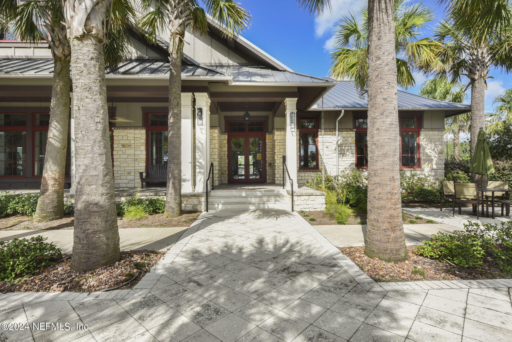 175 Windswept Way Street St. Augustine, FL 32092 - Photo 57 of 80 a view of a brick house with a large windows plants and large tree