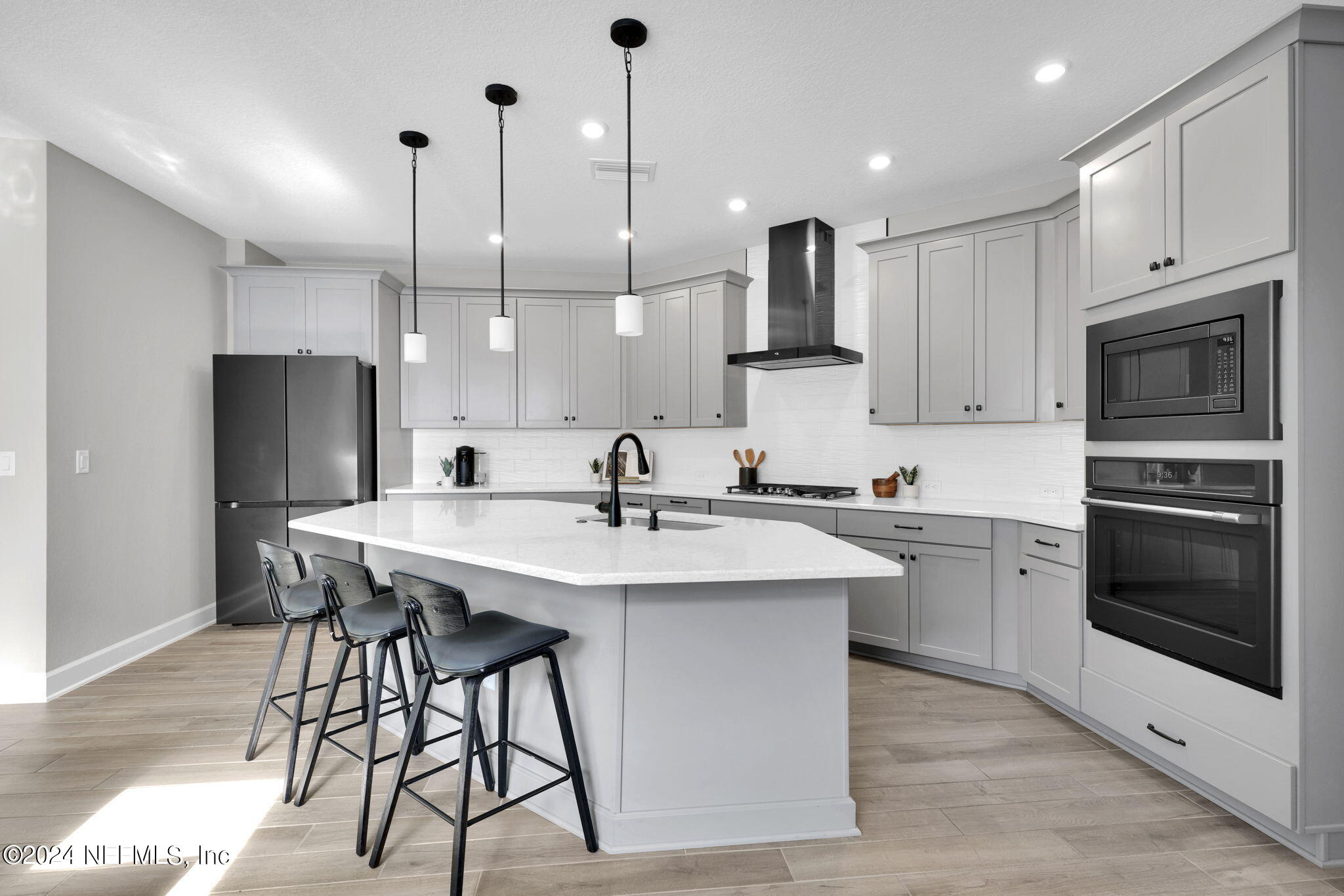 175 Windswept Way Street St. Augustine, FL 32092 - Photo 7 of 80 a kitchen with stainless steel appliances granite countertop a sink a stove a refrigerator and island with wooden floor